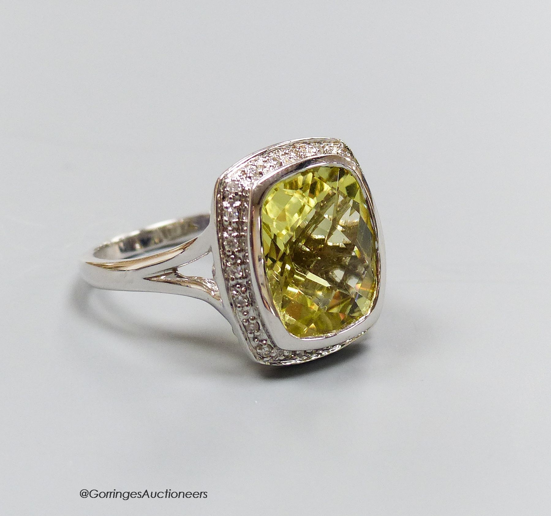 An 18ct white gold, diamond and lemon quartz cluster ring, size N, gross 7.3g.